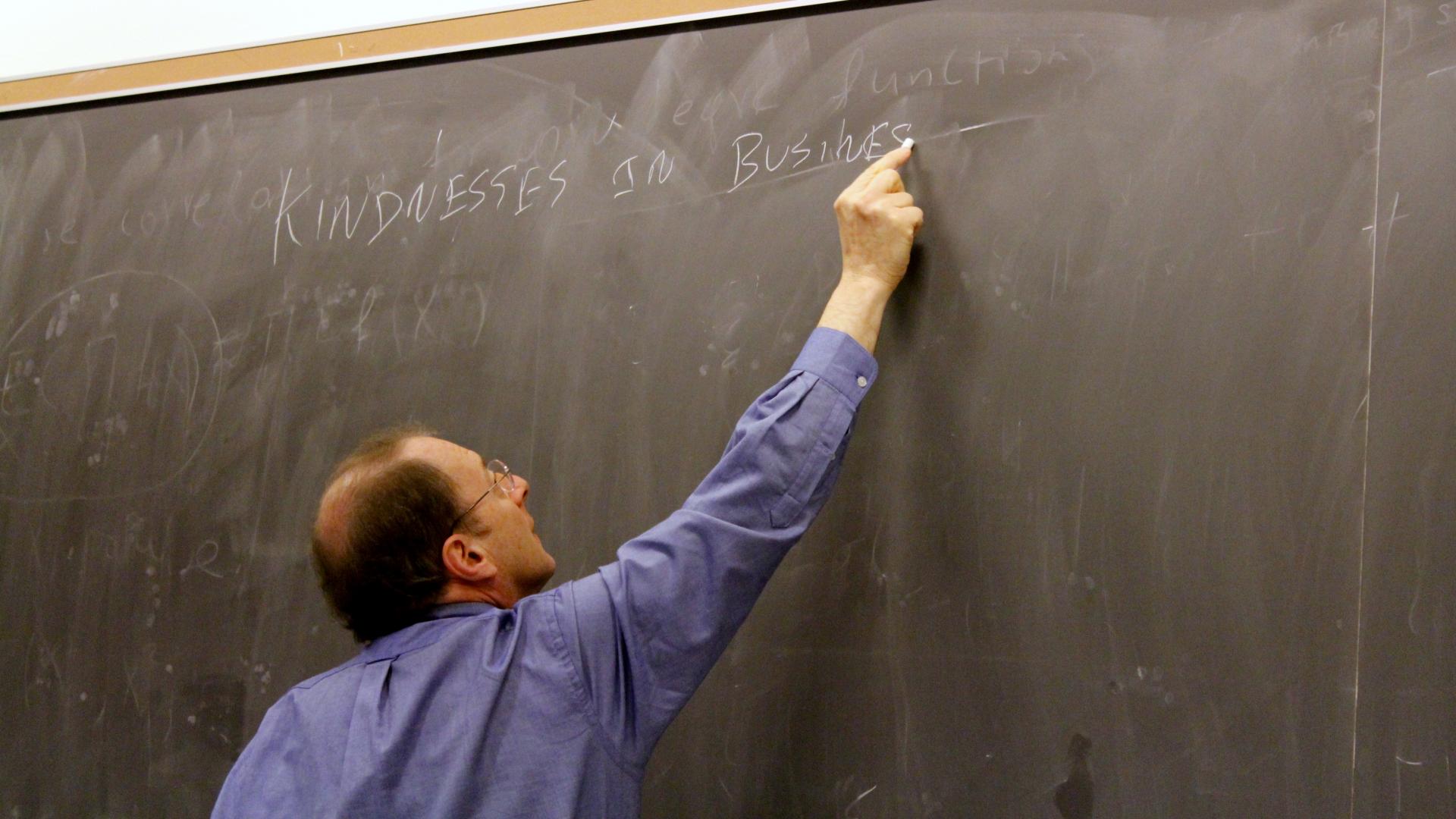 Wharton Professor writing on chalkboard