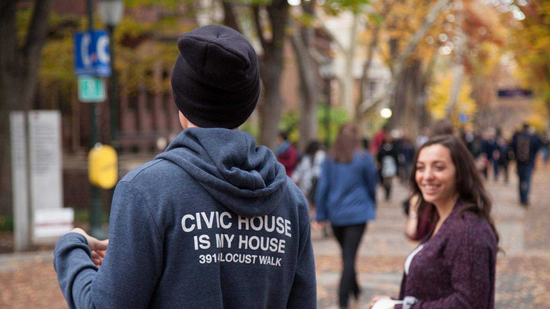 Student on Locust Walk wearing hoodie that says "Civic House Is My House"