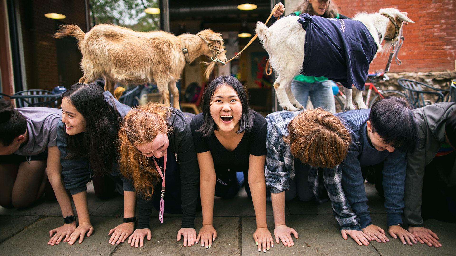 Students posing with goats
