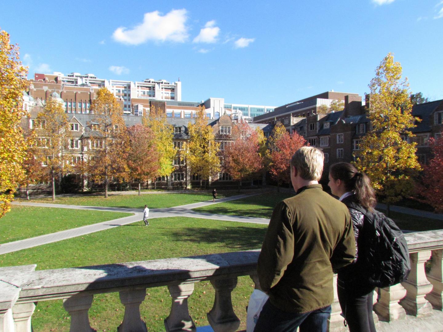 Two students overlooking the Quad dormitory in fall 