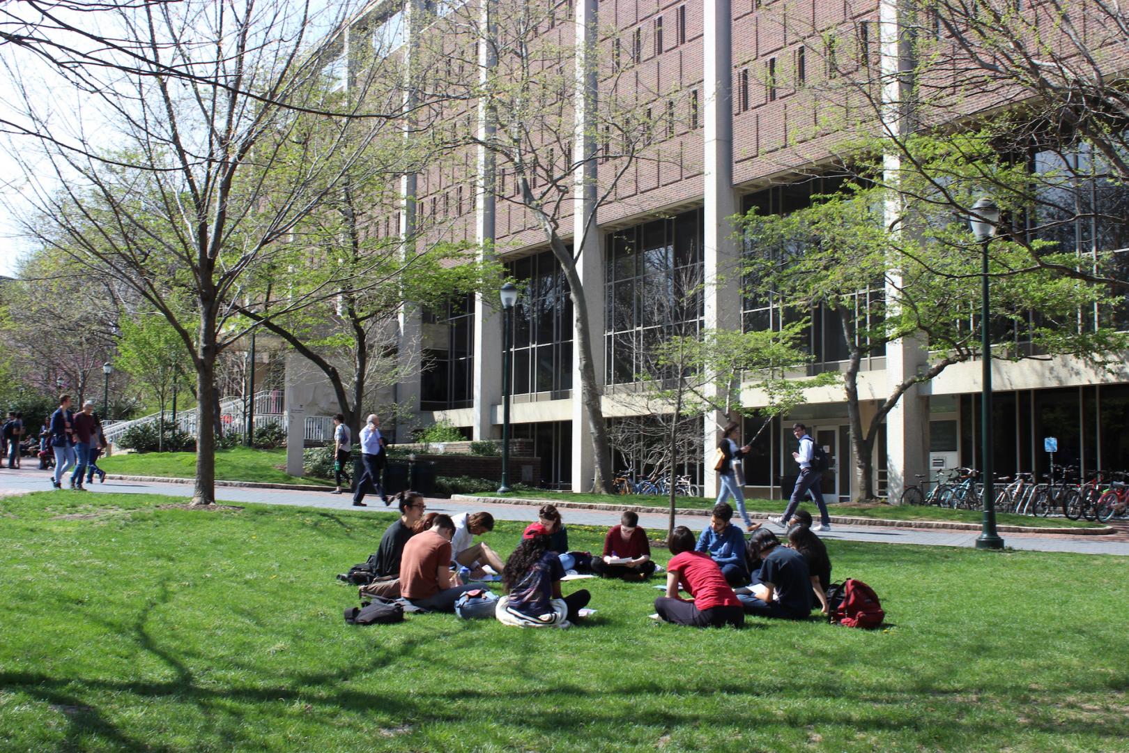 Students sitting on College Green near Van Pelt Library 