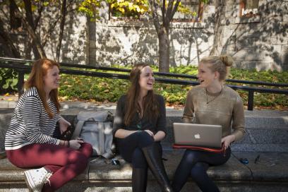 three females students laughing 