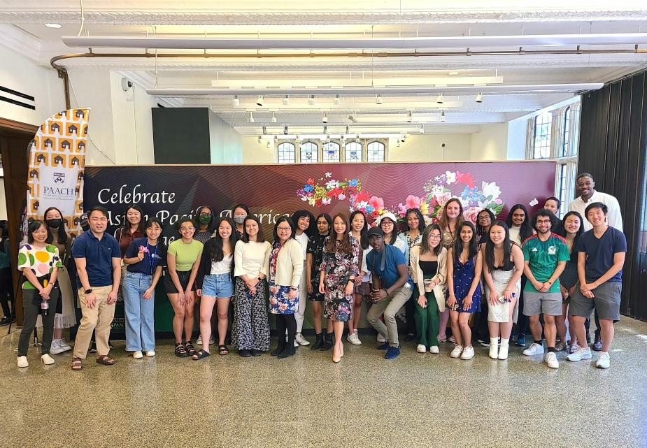 Students and staff from PAACH pose in front of banner celebrating Asian American and Pacific Islander heritage month.