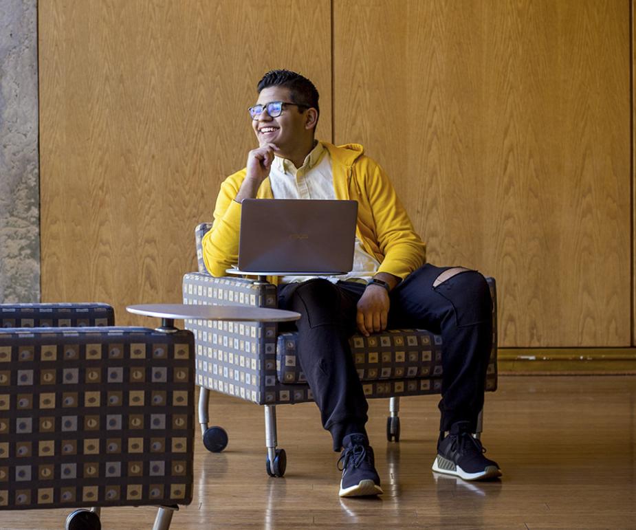 Photo of Bryan sitting with laptop