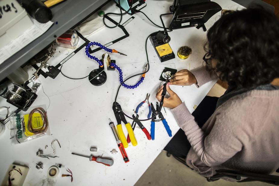 Student working with mechanical engineering tools