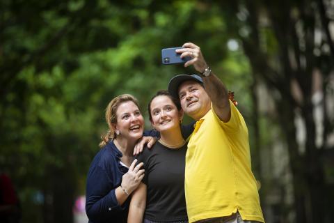 Family taking a selfie on campus