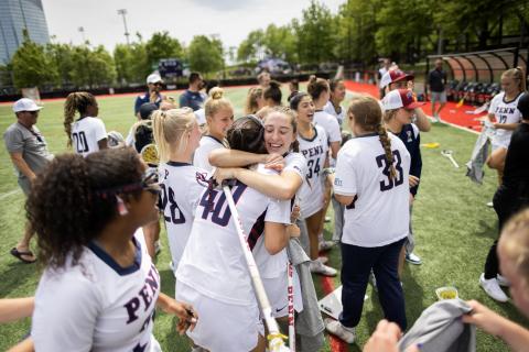 Quakers on the Lacrosse team embrace after victory against the Bulldogs