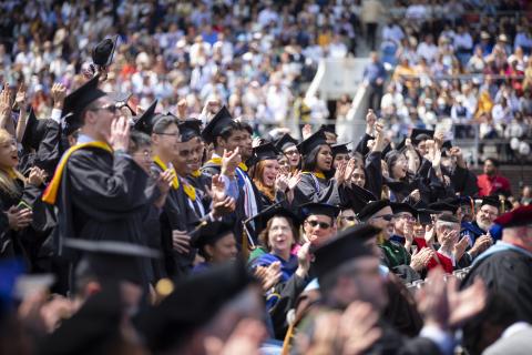 Graduates cheering at Commencement