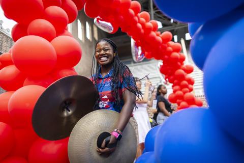 Student playing cymbals on campus