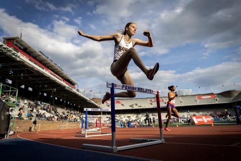 Student clearing hurdles at the Penn Relays