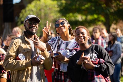 Group of three people smiling at camera