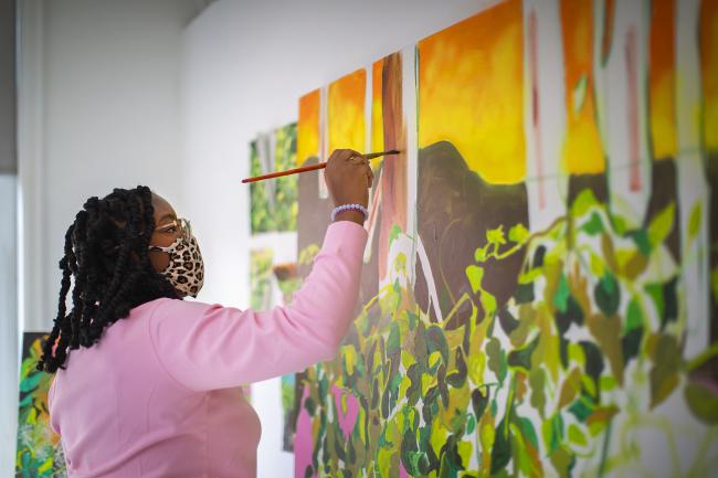 Student painting canvas