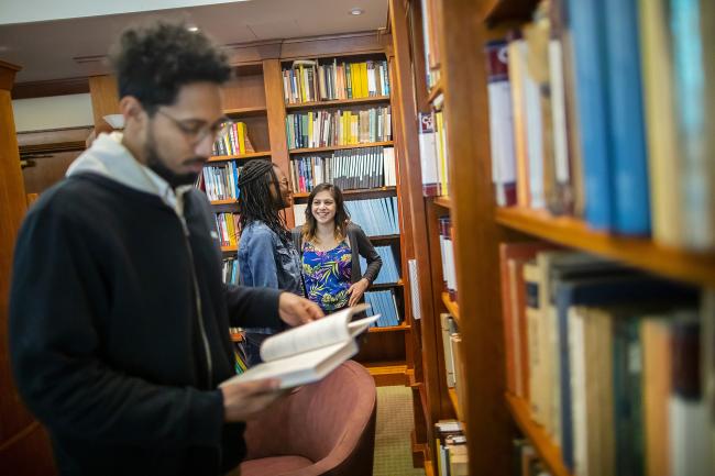 Close-up of student looking through books in Penn Library