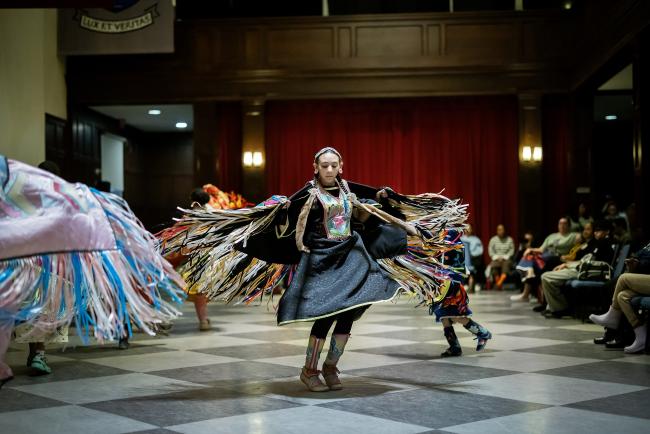 Young woman dances at powwow celebration.