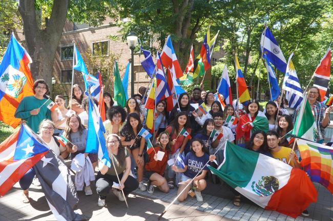 Casa Latina students holding flags from Latin America.