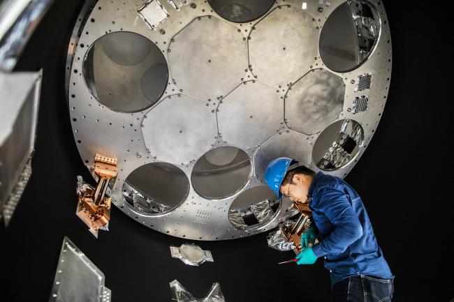 Astronomy student working on large telescope