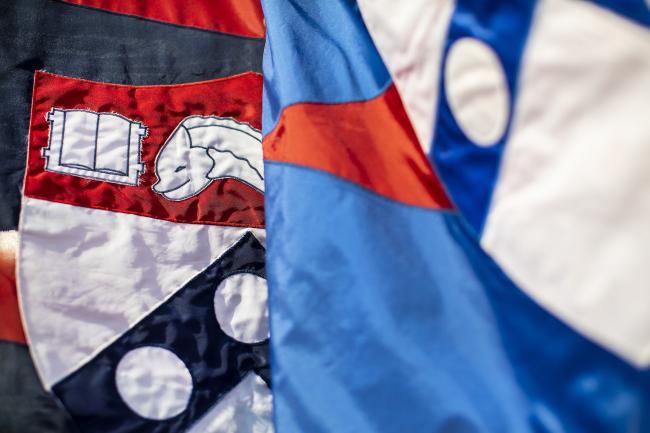 Close ups of two flags with the Penn Shield