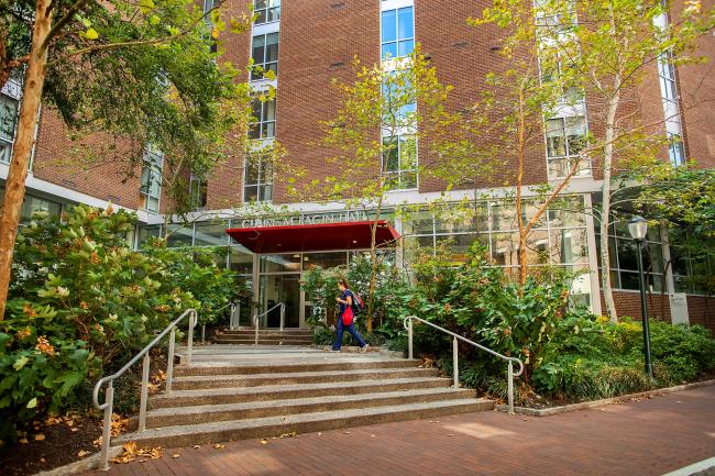 Entrance to Claire M. Fagin Hall with student walking