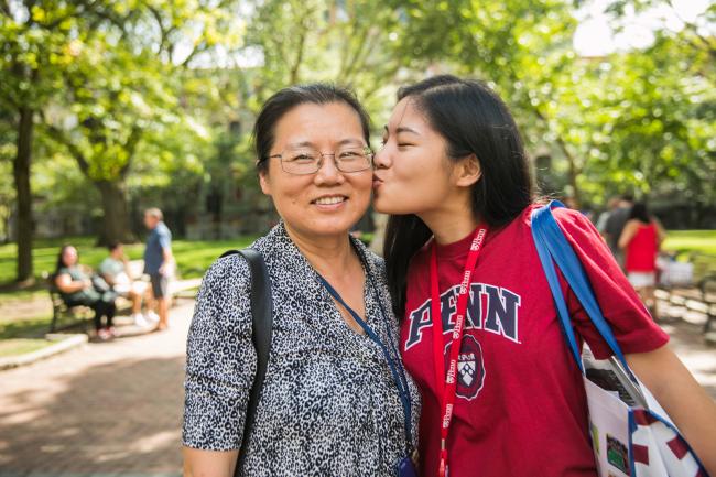 Student kissing parent on the cheek