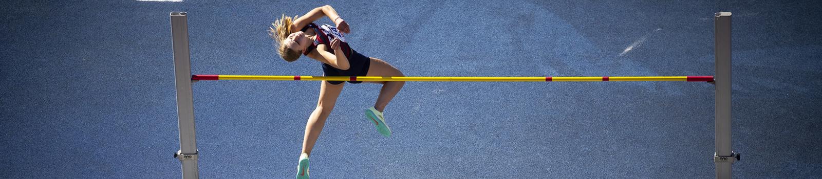 Student pole vaulting at the Penn relays