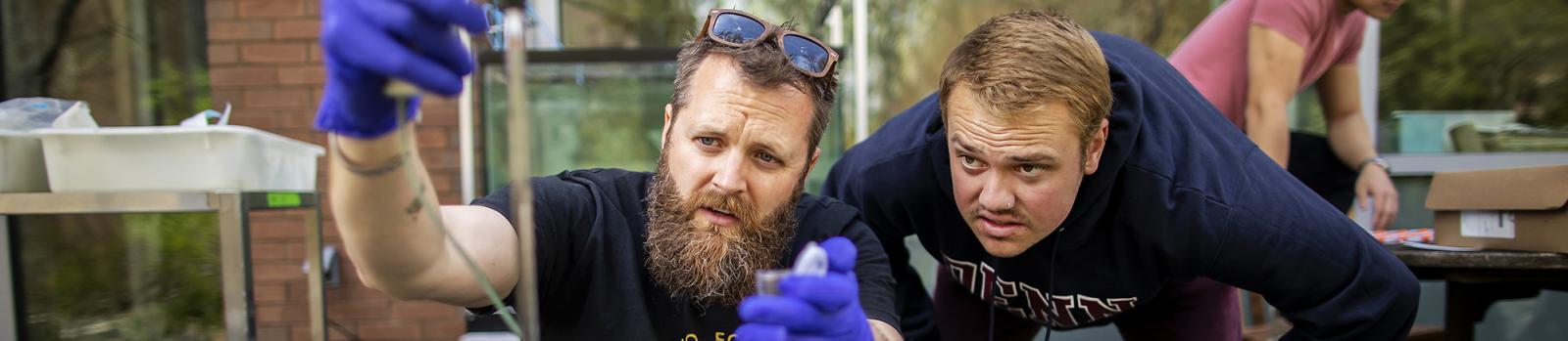 Student and professor conducting experiments with mussels