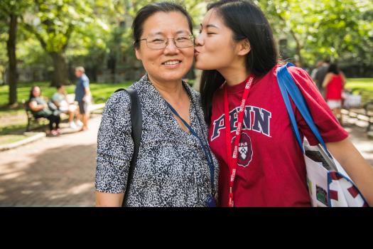 Student kissing parent on the cheek