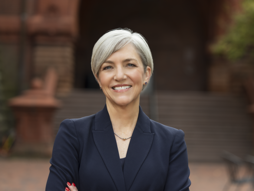 Dean Soule smiling at camera on Penn's campus, wearing a dark blue blazer.